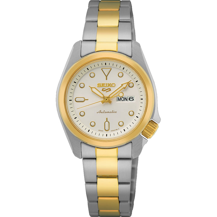 Het Seiko dameshorloge SRE004K1 van Seiko heeft een automatisch uurwerk, een ronde witte wijzerplaat met gouden markeringen en wijzers, een dag-datumaanduiding op 3 uur en een chique tweekleurige zilver-gouden band.