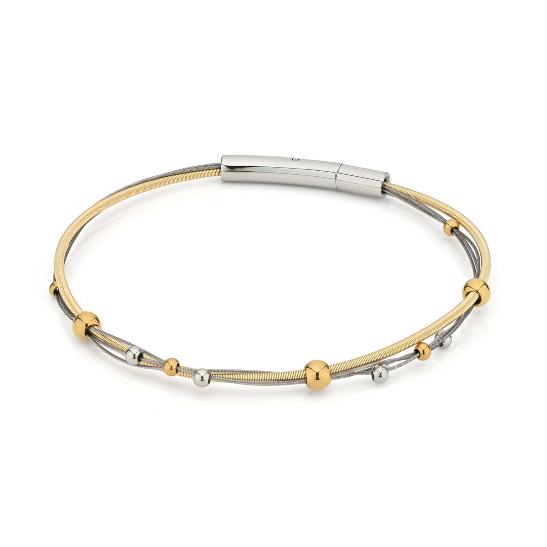 De Armband speelse bolletjes bicolor A269BI van CLIC Creations is een strakke armband gemaakt van hypoallergeen chirurgisch roestvrij staal, met goud- en zilvertinten. Het heeft een dunne band met kleine metalen kralen en een moderne sluiting, die minimalistische elegantie belichaamt voor elke gelegenheid.
