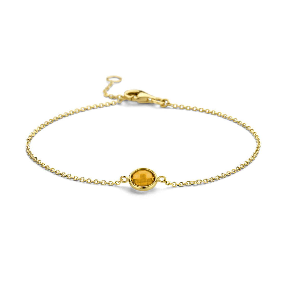 De Gouden armband dames citrien 14K uit de Van der Kooij Collectie is een verfijnde 14k geelgouden armband met een centrale ronde citrien en een veilige karabijnsluiting.
