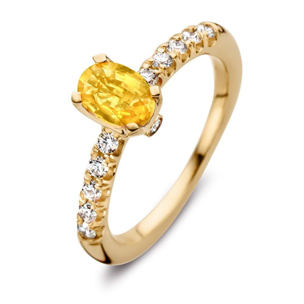 Złoty pierścionek z żółtym szafirem i diamentami o łącznej wadze 0,54 ct.