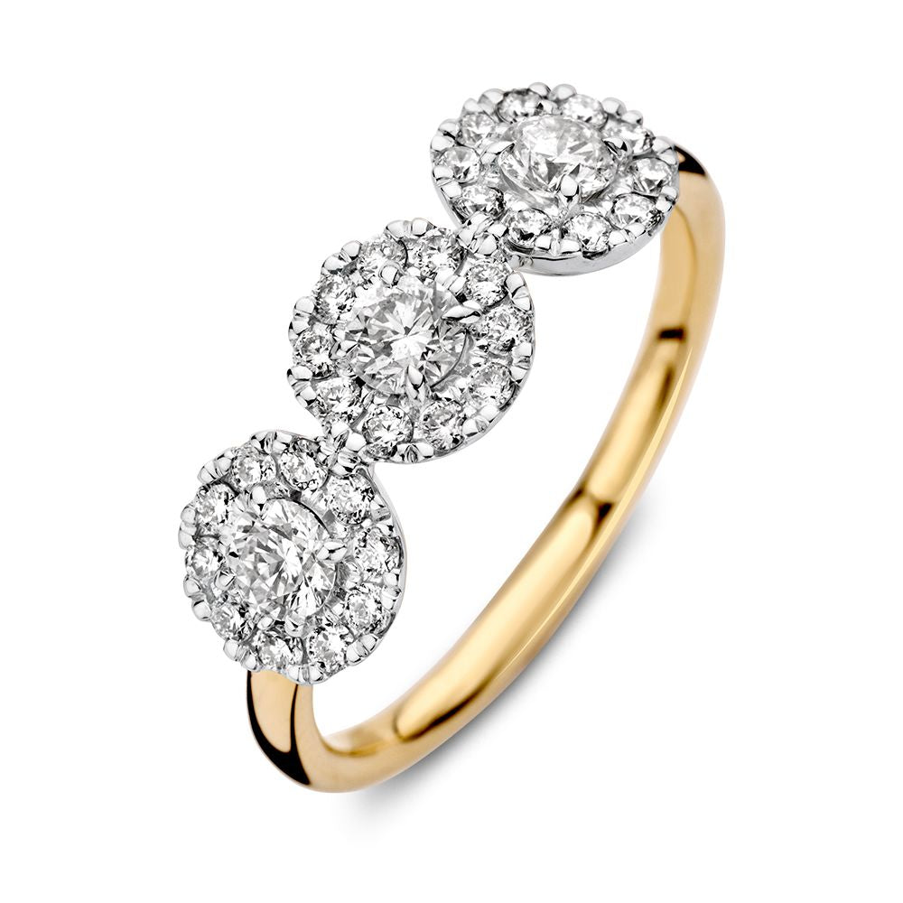 Bicolor złoty pierścionek z trzema diamentami o łącznej wadze 0,81 ct w oprawie.