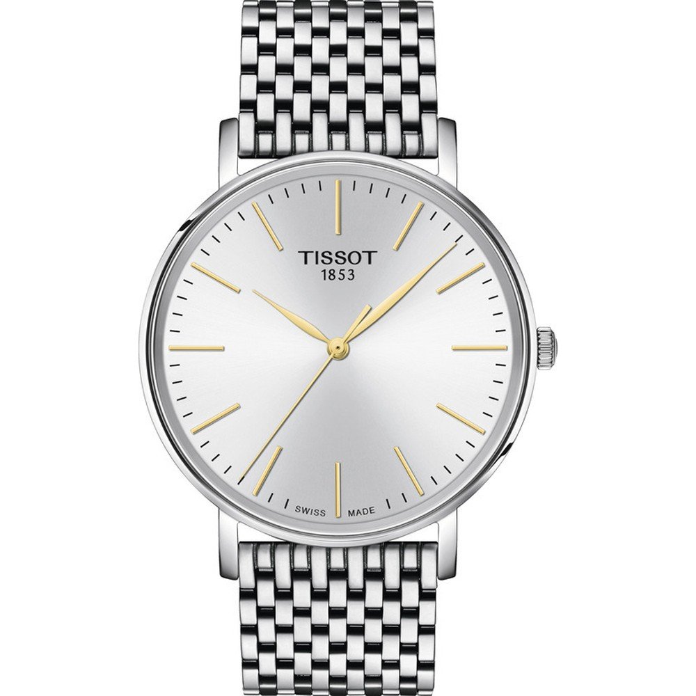 Srebrny zegarek Tissot z okrągłą tarczą, złotymi wskazówkami i metalową bransoletą.